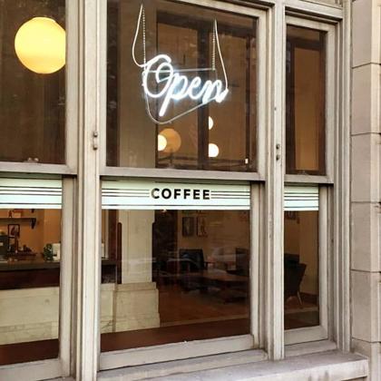 Lift Bridge Coffee's storefront with a lit Open sign in the window