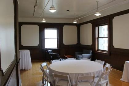 The Parlor with round tables and chairs near the windows